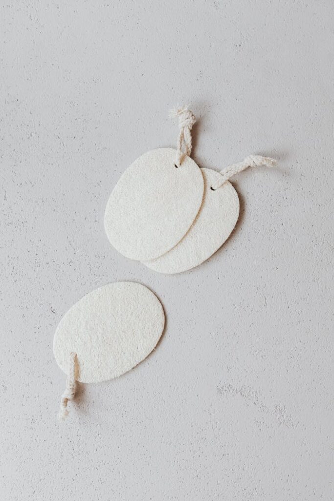 White textured tags with twine on a subtle background, perfect for adding personalized messages.